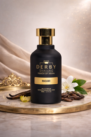 Black perfume bottle with gold cap on a decorative tray with flowers and vanilla beans, against a beige background.