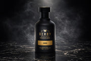 Black perfume bottle with gold label on a dark textured background