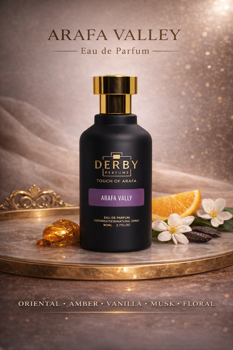 Derby perfume bottle with 'Arafa Valley' on a decorative platform with flowers and an orange.