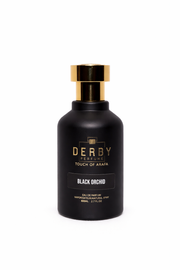 Black perfume bottle with gold cap labeled 'Derby' on a white background